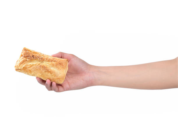 istock puff pastry in female hand isolated on white background 1157206130