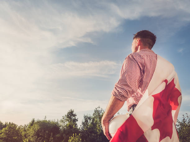 istock Engineer in a white helmet and Canadian Flag 1157210411