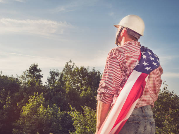 istock Engineer in a white helmet and American Flag 1157210478