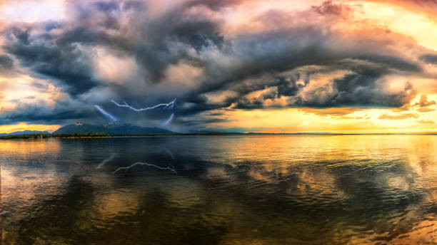 Thunderstorm front over the Kampenwand and Lake Chiemsee Thunderstorm front with beautiful sunset in the background gewitter stock pictures, royalty-free photos & images