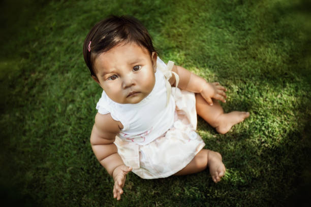 istock A child sitting by herself that is looking up with distrust and looks worried or abandoned. 1157213707