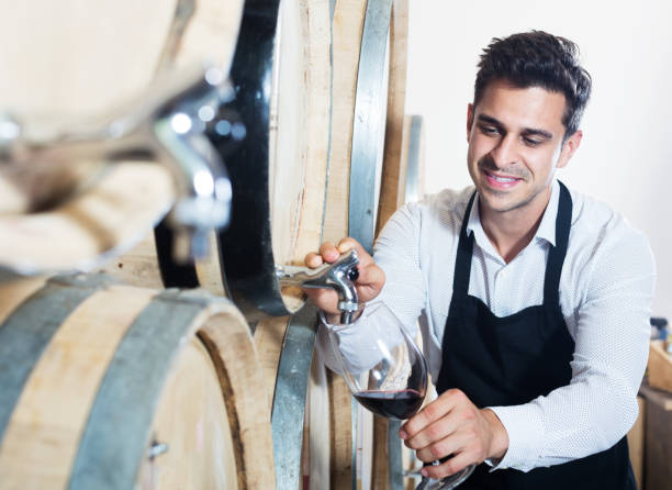 istock Seller pouring wine in cellar 1157214048