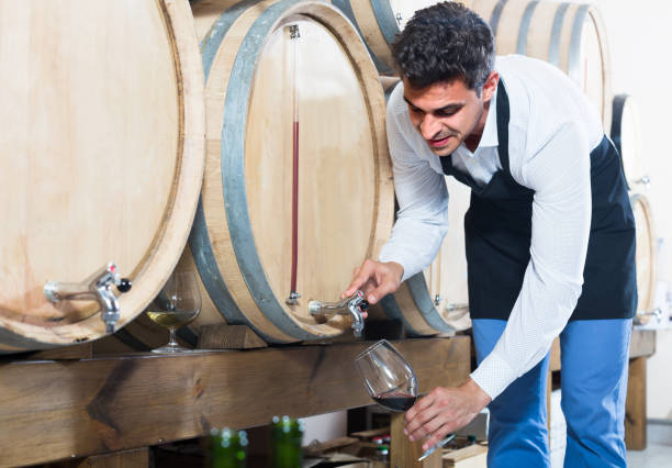 istock seller taking wine from wood 1157214055
