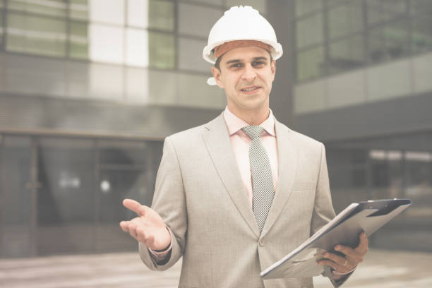 istock Smiling businessman reading papers 1157214078