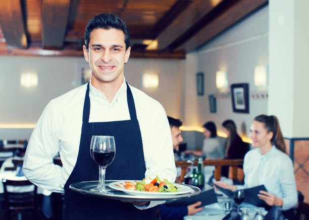 istock Smiling waiter with serving tray 1157214091