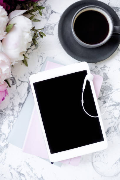 istock Romantic morning time with flowers, coffee and tablet. View from the top. 1157215611