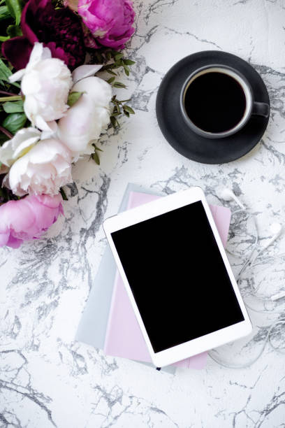 istock Romantic morning time with flowers, coffee and tablet. Flat lay.. 1157215612