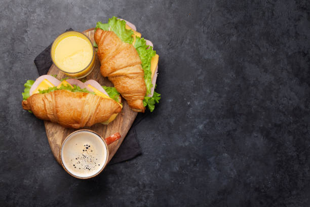 istock Coffee, orange juice and croissant sandwich 1157218523
