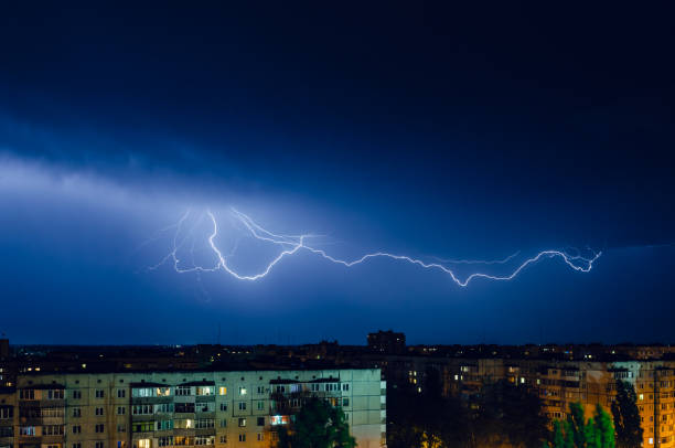 istock Thunderstorm with lightning and thunder over the night city 1157219741