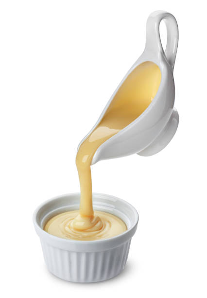 istock Pouring condensed milk isolated on white background 1157219870