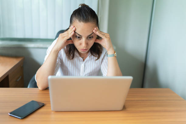 istock Stressed business woman working on a laptop 1157224111