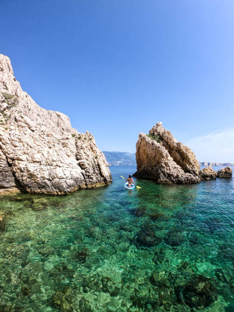 istock Woman paddling between rocks 1157225227