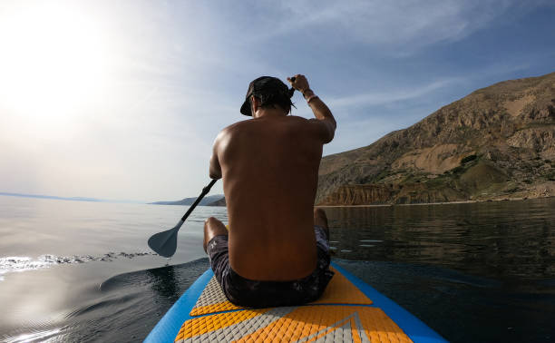 istock Man paddling over sea closeup 1157227478