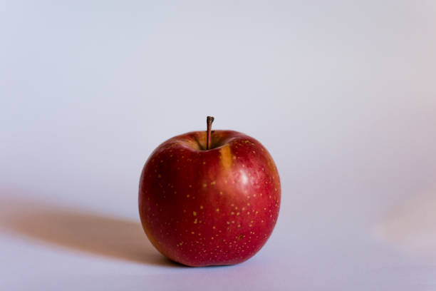 istock One apple in closeup on a white background 1157231311