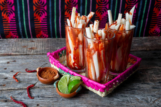 Mexican jicama fruit cutted with lime, chili powder and chamoy Mexican jicama fruit cutted with green lime, chili powder and chamoy pachyrhizus erosus stock pictures, royalty-free photos & images