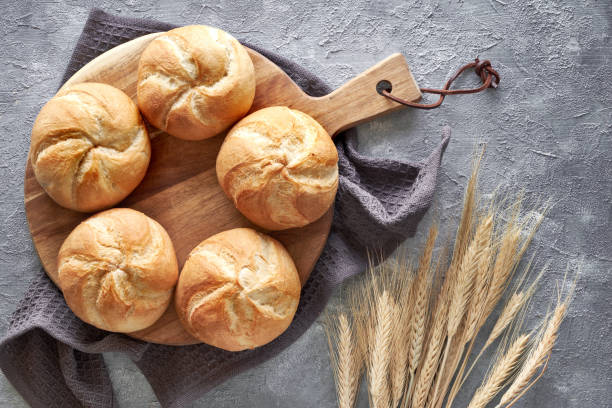 istock Crusty round bread rolls, known as Kaiser or Vienna rolls on linen towel 1157232509
