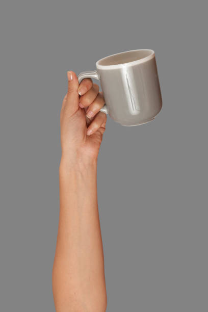 istock arm raised hands up and holding coffee cups 1157234046