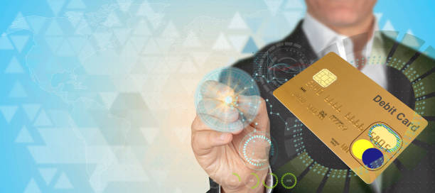 istock Businessman pointing 3D debit card object with pen in HUD design technological background with copy space 1157234147