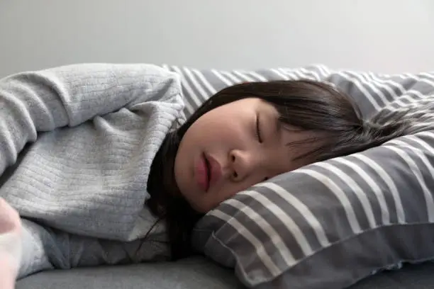 Photo of Child girl sleeping on bed