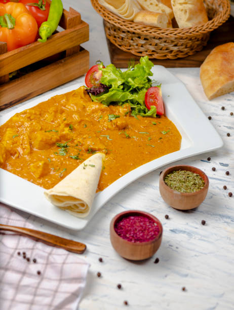 istock Indian curry with chicken breast and tomato sauce served with lavash. 1157235218