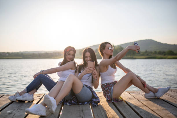 istock Young women having fun by the lake 1157235343