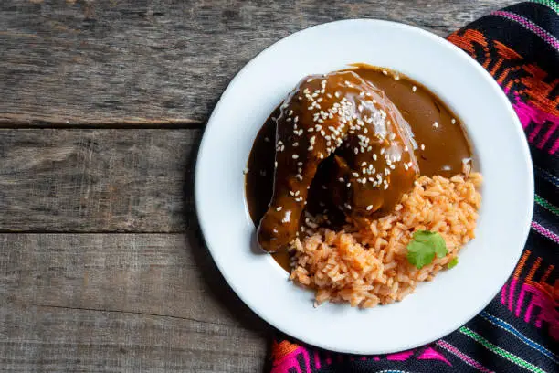 Traditional mexican chicken with mole sauce and red rice