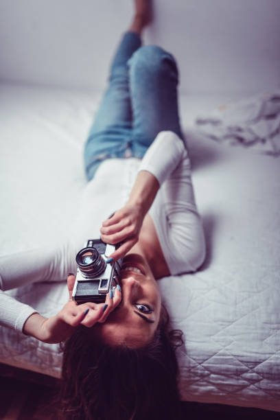 istock Female Taking A Bedroom Photograph 1157237025