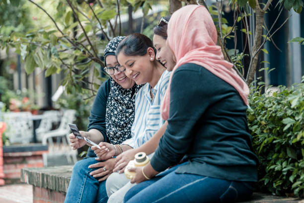 istock Multi ethnic friends watching an instant print photo 1157239332