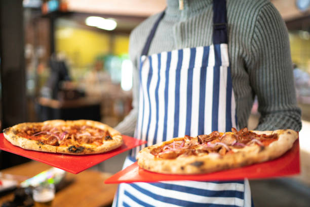 Helpful waitress brought delicious pizza to restaurant guests