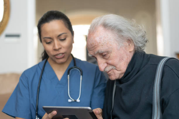 istock Elderly Gentleman With Nurse During Home Care Visit 1157244053