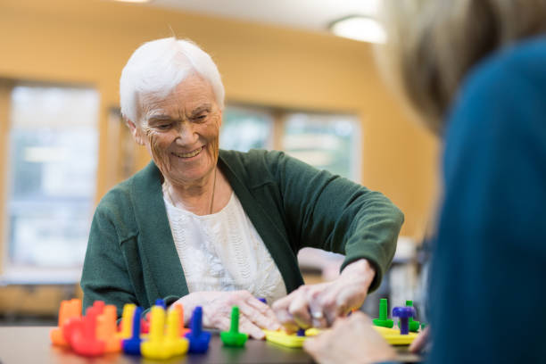 istock Occupational therapist works with an elderly woman 1157244323