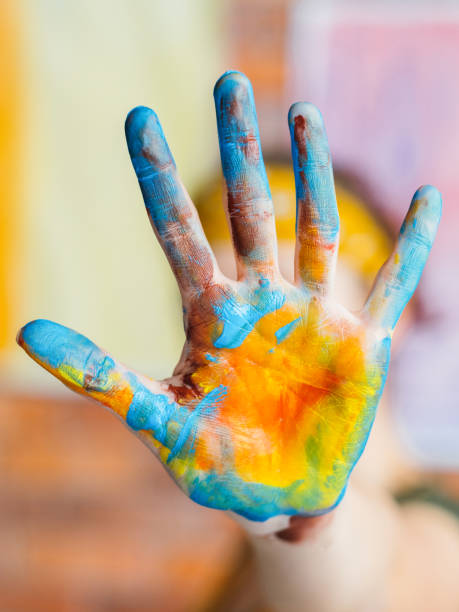 istock finger painting art trend blue yellow colored hand 1157244413