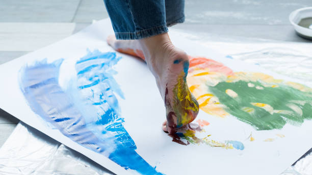 istock foot painting technique artist abstract artwork 1157244415