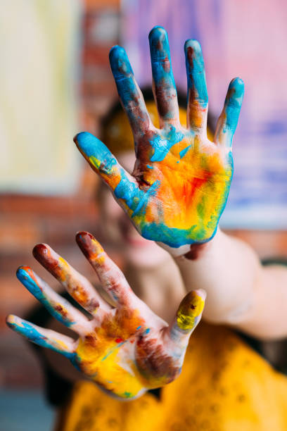 istock creative hobby artist hands blue yellow paint 1157244416