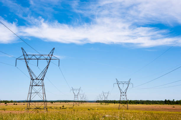 istock Electrical transmission towers and power lines on fields. 1157244783