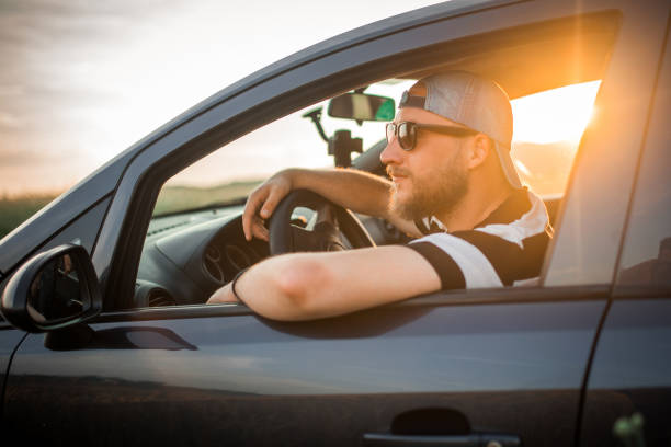 istock Young man on a road trip with car 1157246174
