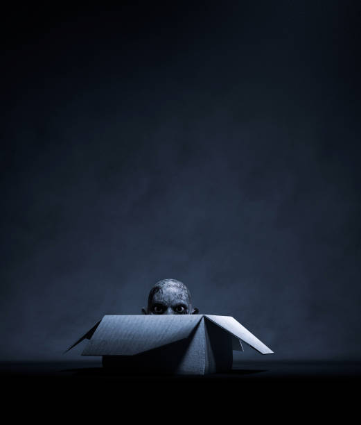 istock Monster head hiding in a open cardboard box 1157249760