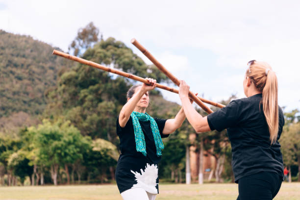 istock Two senior women training with combat stick 1157255849