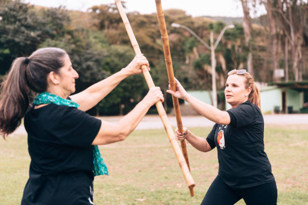 istock Two senior women training with combat stick 1157255905