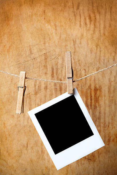 istock Blank picture frame hanging on clothesline 115726395