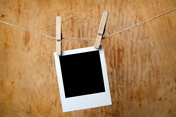 istock Blank picture frame hanging on clothesline 115726399