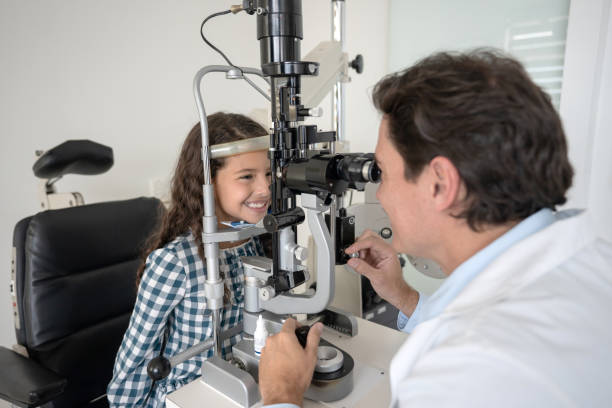 istock Happy girl at the ophthalmologist getting her eyes checked 1157264096