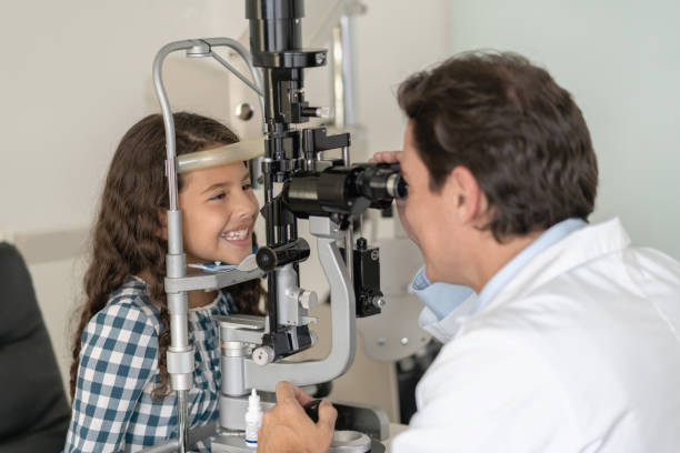 istock Happy girl at the optometrist getting her eyes checked 1157266742