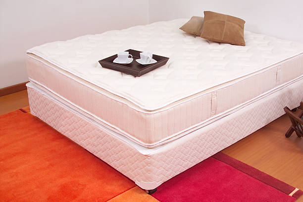 istock Unmade bed with tray of coffee 115726771