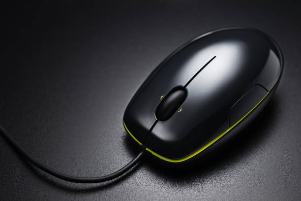 istock Black wired mouse on the dark office desk 1157268364