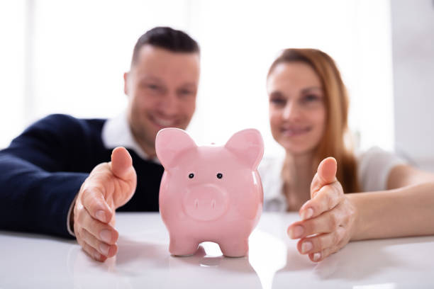 istock Couple's Hand Protecting Piggybank 1157269285