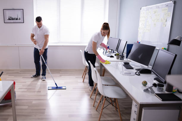 istock Smiling Two Young Janitor Cleaning The Office 1157269325