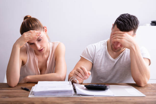 istock Stressed Couple Looking At Invoice 1157269346