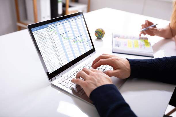 istock Businessman's Hands Working On Gantt Chart On Laptop 1157269660