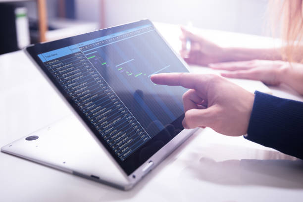 istock Businessman's Hand Showing Gantt Chart On Laptop Screen 1157269661